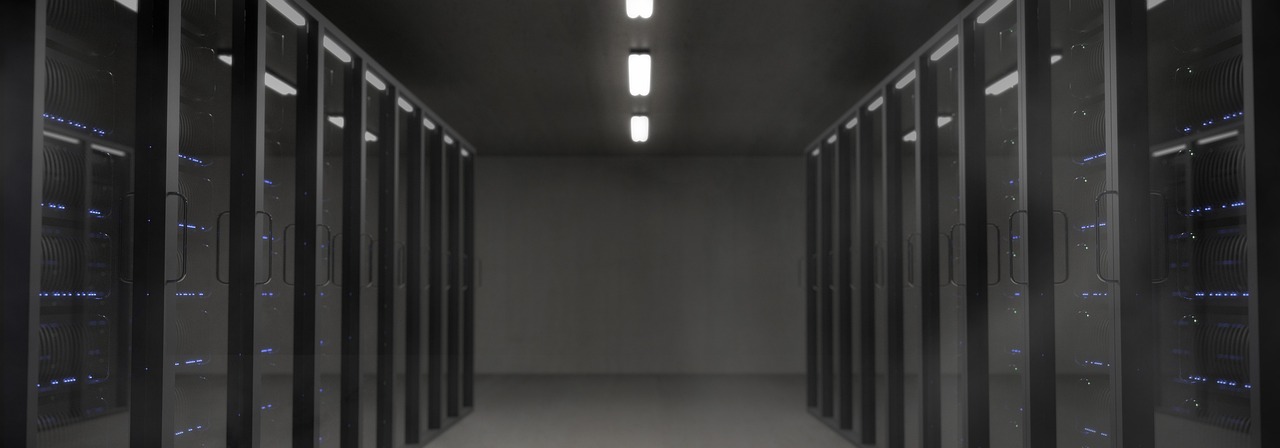 Dark server room corridor with blue rack lights
